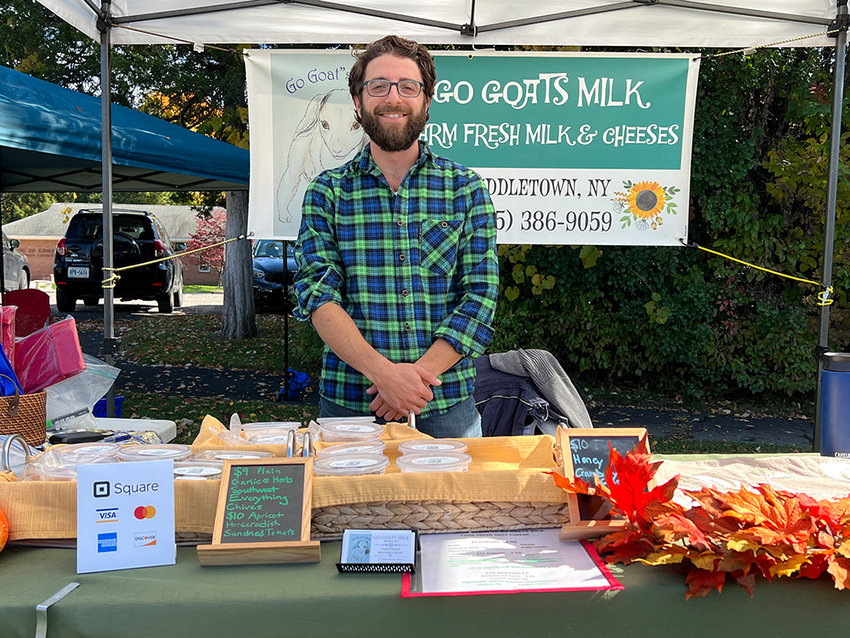 Terence Pologe of Go Goats Milk welcomes you to his booth with some samples of goat cheese.