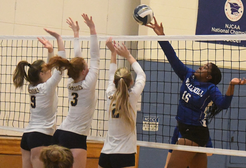 Wallkill&rsquo;s Madisen Noelizaire tips the ball over the net as Our Lady of Lourdes&rsquo; Madison Tegeler (9), Abigail Anderson (3) and Molly Quirk (2) defend, and Vanessa Seymour looks on during Wednesday&rsquo;s MHAL semifinal volleyball match at SUNY Ulster.