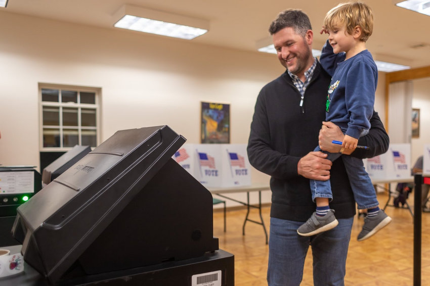 Congressman Pat Ryan cast an early ballot Sunday at the New Paltz Community Center, with help from his son Theo.