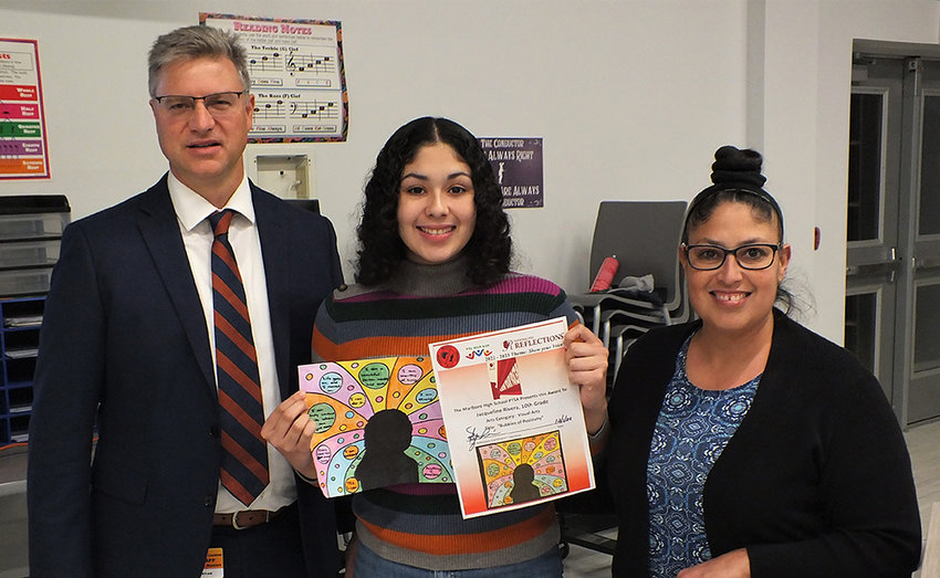 Jacqueline Rivera holds her &lsquo;Bubbles of Positivity&rsquo; art work while standing beside Principal Ryan Lawler and Myra Rivera.
