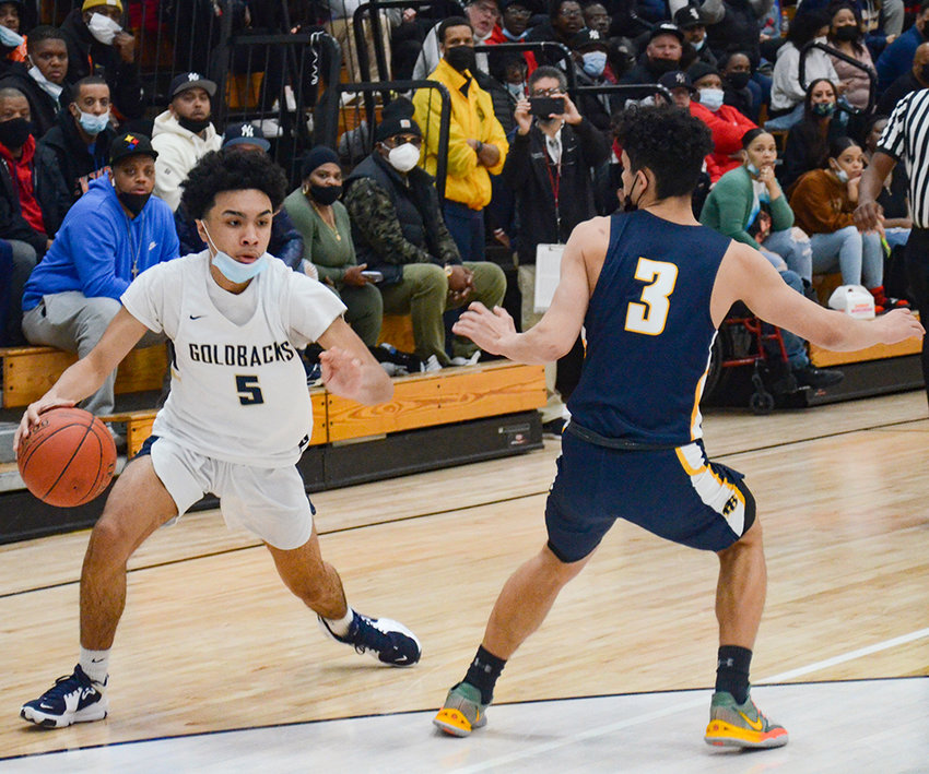 Newburgh&rsquo;s Aidan Brown dribbles the basketball as Pine Bush&rsquo;s Jacob Santiago defends during a Section 9 Class AA semifinal boys&rsquo; basketball game on Feb. 27 at Newburgh Free Academy.