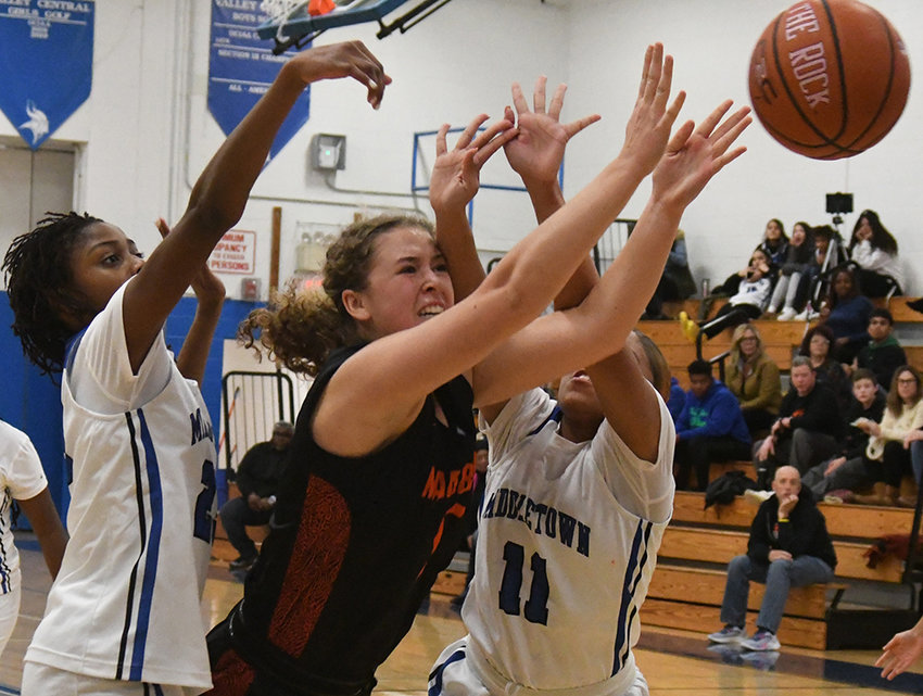 Marlboro&rsquo;s Hannah Polumbo fights through the defense of Middletown&rsquo;s Ashley MacCalla and Jalissa Ocasio (11) defends during Thursday&rsquo;s Corinne Feller Memorial Tip-Off tournament championship girls&rsquo; basketball game at Valley Central High School in Montgomery.