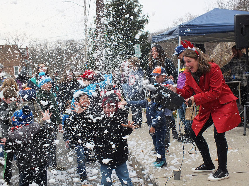 Vivian Lanzarone enthusiastically blew snow out across the kids at the Milton tree lighting ceremony, Sunday afternoon.