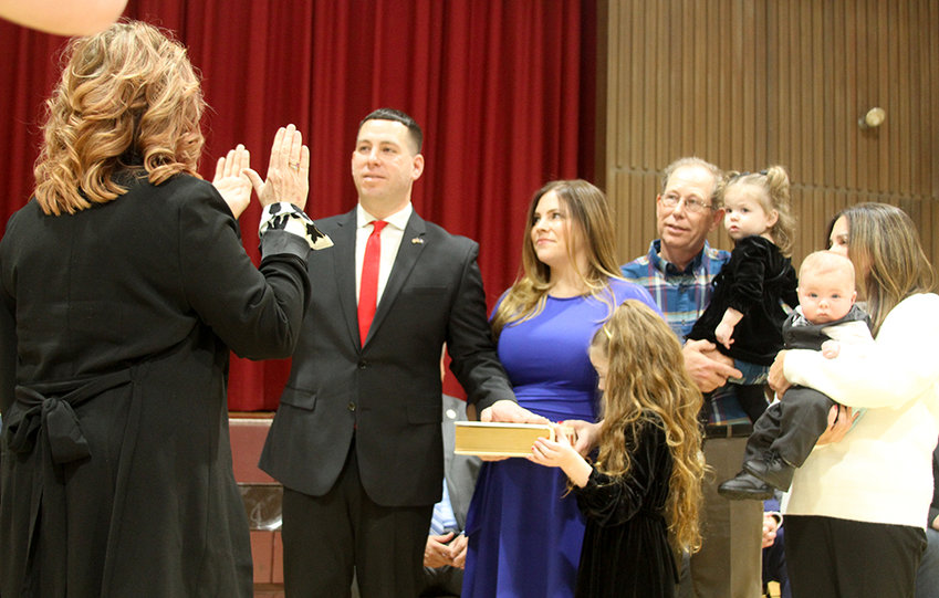 With family at his side, Assemblyman Brian Maher takes the oath of office from Kelly Eskew, Orange County Clerk.