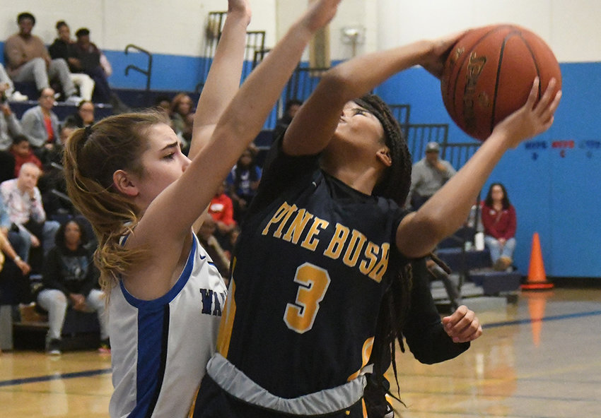 Pine Bush&rsquo;s Leticia Watson puts up a shot as Wallkill&rsquo;s Zoe Mesuch defends during Friday&rsquo;s Coaches vs. Cancer Tournament championship girls&rsquo; basketball game at Wallkill High School.