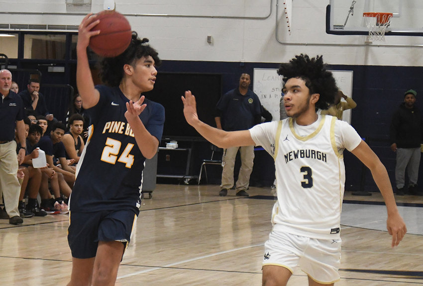 Pine Bush&rsquo;s Jalen Ali passes the ball as Newburgh&rsquo;s Aidan Brown defends during Friday&rsquo;s OCIAA crossover boys&rsquo; basketball game at Newburgh Free Academy&rsquo;s Main Campus.