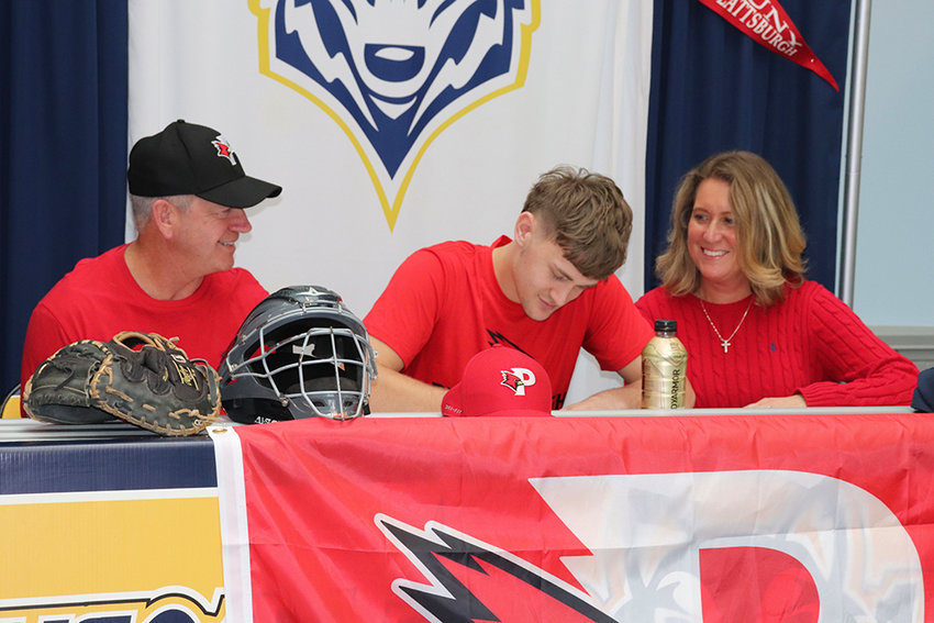 Highland&rsquo;s Ian Warren, center, signs his commitment to play baseball at SUNY Plattsburgh as his parents look on at Thursday&rsquo;s signing event at Highland High School.