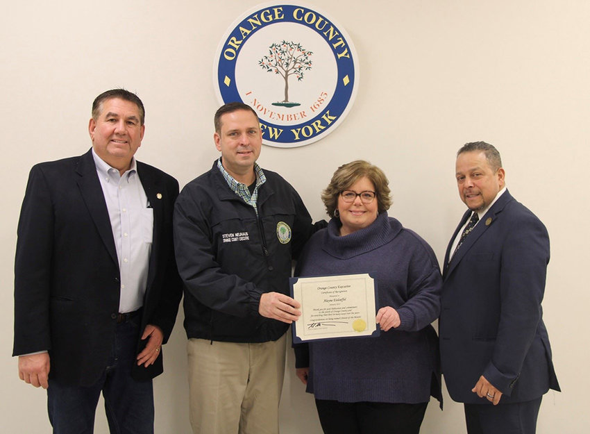 Alayne Eisloeffel was honored as Orange County Citizen of the Month by Orange County Executive Steven M. Neuhaus. They were joined by Orange County Legislator Rob Sassi (l.) and Town of Wallkill Supervisor George Serrano (r).