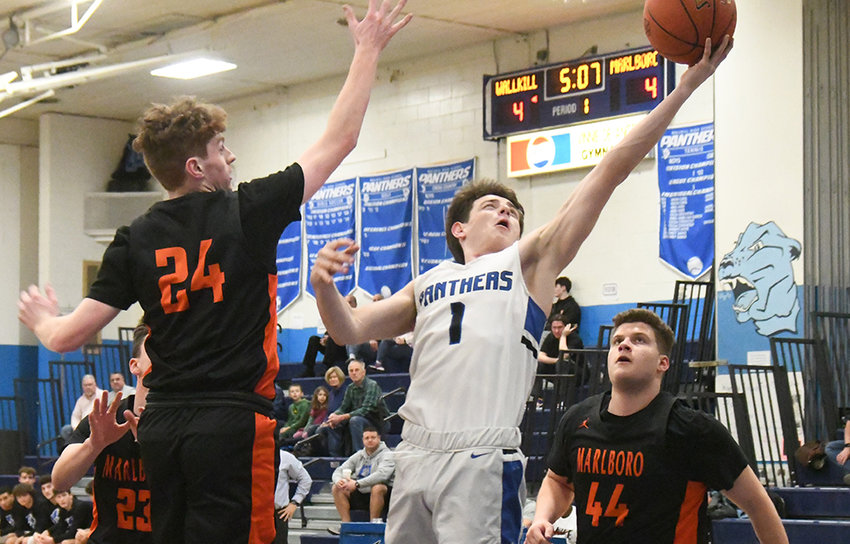 Wallkill's Chris Baccaro puts up a shot as Marlboro's John Ryder defends and Thomas Benfer (44) looks on during Friday's MHAL boys' basketball game at Wallkill High School.