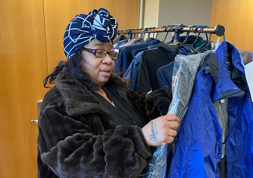 Carla Johnson inspects one of the coats available.