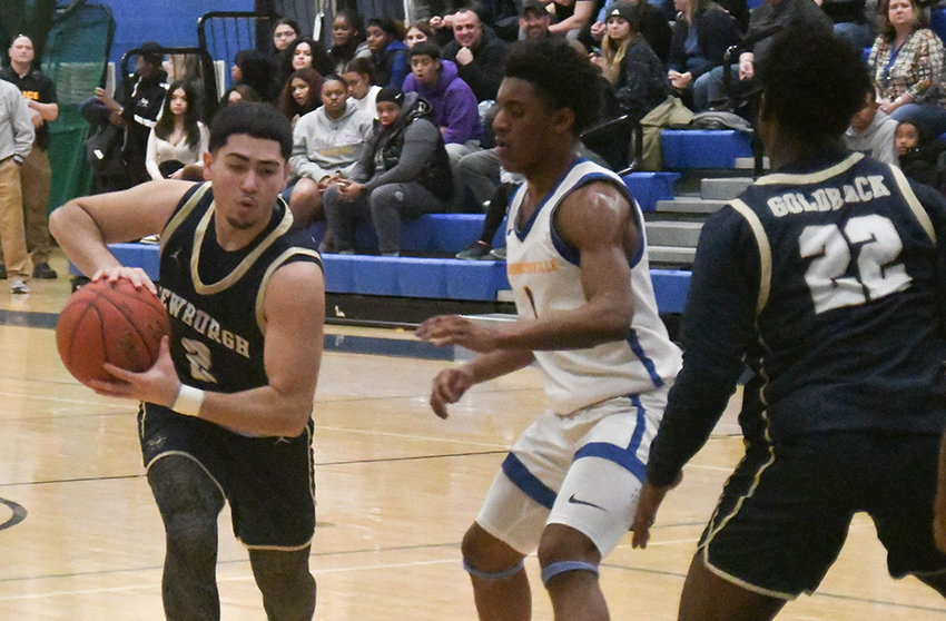 Newburgh's Jaydan Lorenzo drives toward the basket as Washingtonville's Ethan Garcia defends and Newburgh's Darryl Jackson (22) looks on during Friday's OCIAA boys' basketball game at Washingtonville High School.