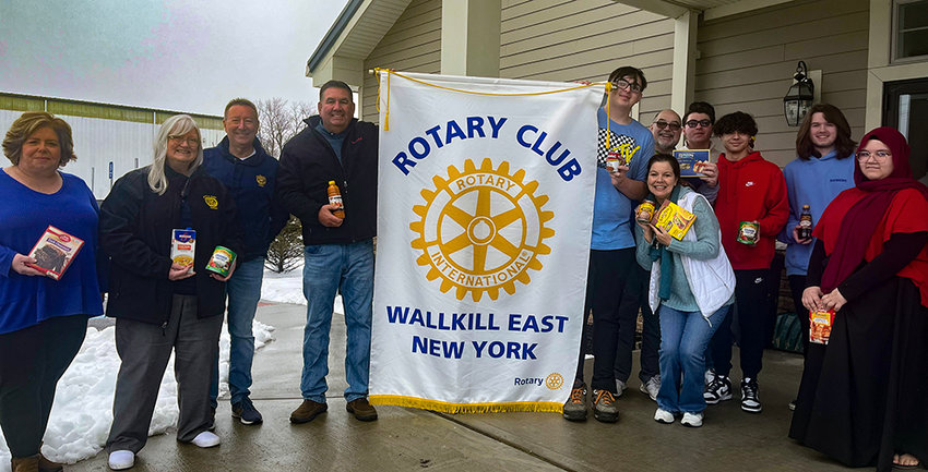 Legislator Robert C. Sassi, Peggy Lucido, Sal Lucido, fellow Rotary members, Interact Club members and others gather for a photo at the food drive.