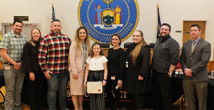 Kirsten Droney was named the Marlboro Elementary School Student of the Month for February. Pictured L-R board member James Mullen, Droney&rsquo;s parents, Principal Jena Thomas, Kirsten Droney, Asst. Principal Sarah Amodeo, music teachers Susan Johnston and Zachary Povall and Superintendent Michael Rydell.
