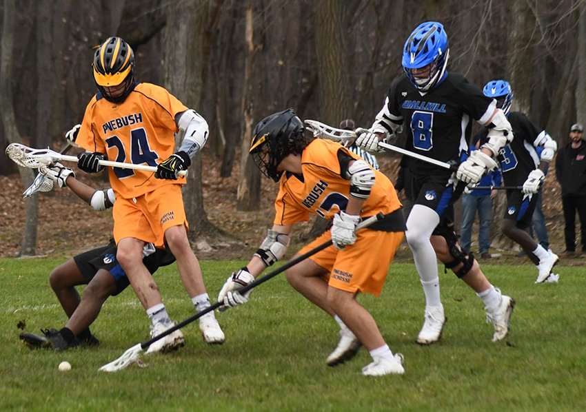Pine Bush's Nick Mazzella scoops up the ball in front of teammate Angelo Zullo as Wallkill's Richie Martinez trails the play during a non-league boys' lacrosse game on March 27 at Pine Bush Elementary School.