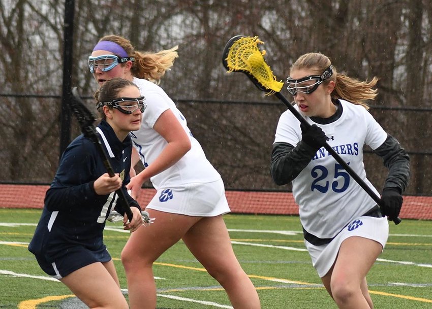 Wallkill's Abigail Martino runs down the field with the ball as Newburgh's Emily Leonard turns to defend and Wallkill's Brianna Merril looks on during Friday's non-league girls' lacrosse game at Wallkill High School.