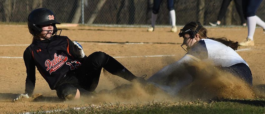 Highland catcher Delaney Reid tries to tag Marlboro&rsquo;s Emma Jackson at home plate during Thursday&rsquo;s non-league softball game at Highland High School.