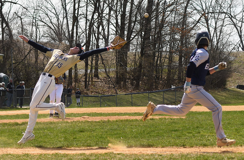 Newburgh first baseman D.J. Clifford reaches back for a pop-up as Burke Catholic&rsquo;s Mason Gove runs to first base during Saturday&rsquo;s non-league baseball game at the Gidney Avenue Field in Newburgh.