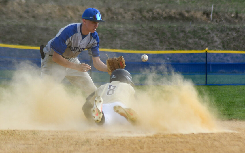 Newburgh's Nick Schmidt dives into second base as the ball skips by Valley Central second baseman Chris Byrne during Wednesday's OCIAA crossover baseball game at the Gidney Avenue Field in Newburgh.