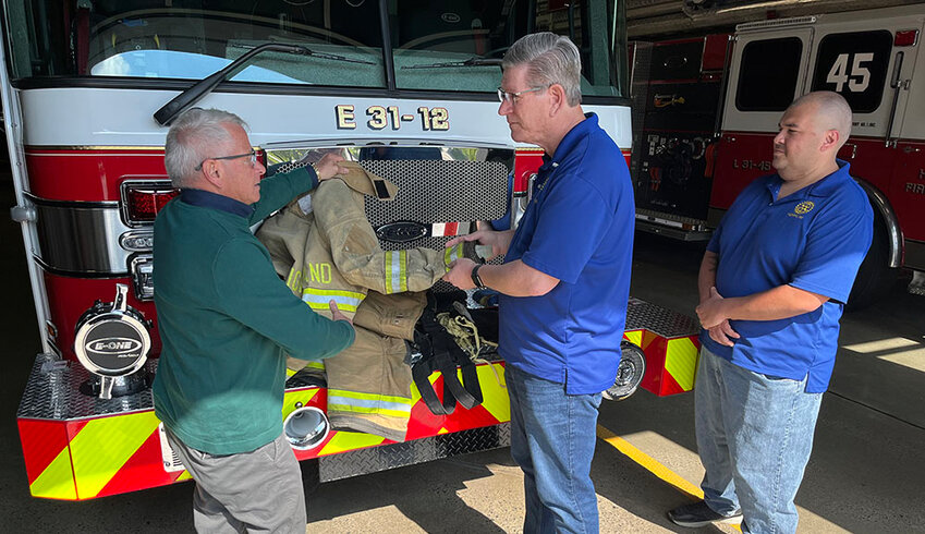 Peter Miller, Highland Fire Department Chief, discusses safety gear with Steve Laubach, President-Elect of Highland Rotary Club and chair of the Golf Outing Committee; and Ruy Alencar, Highland Rotarian and Golf Outing Committee Member. The Highland Rotary Club is hosting a Golf Outing fundraiser on May 12 at Apple Greens Golf Course in Highland to raise funds to help support the purchase of updated personal protective equipment for the volunteer firefighters.