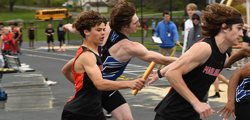 Marlboro&rsquo;s Sean Robertson hands the baton to Drew Heimink during the boys&rsquo; 4x100-meter relay during Friday&rsquo;s Iron Duke Relays track and field meet at Marlboro High School.