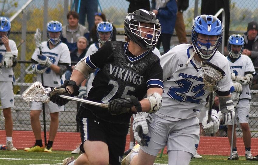 Valley Central's Bryson Antal brings the ball toward the goal as Wallkill's Sean Petricek pursues during Thursday's boys' lacrosse game at Wallkill High School.