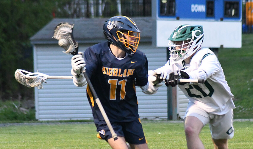 Highland's Liam Conn brings the ball out from behind the goal as Cornwall's Lucas Russo defends during Wednesday's non-league boys' lacrosse game at Kristi Babcock Memorial Park in New Windsor.