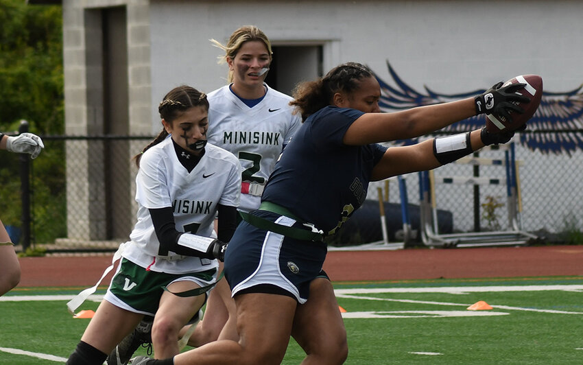 Newburgh's Salma Martinez runs the ball as Minisink Valley's Julia Fratto goes for the flag during Friday's flag football game on Friday at Academy Field in Newburgh.