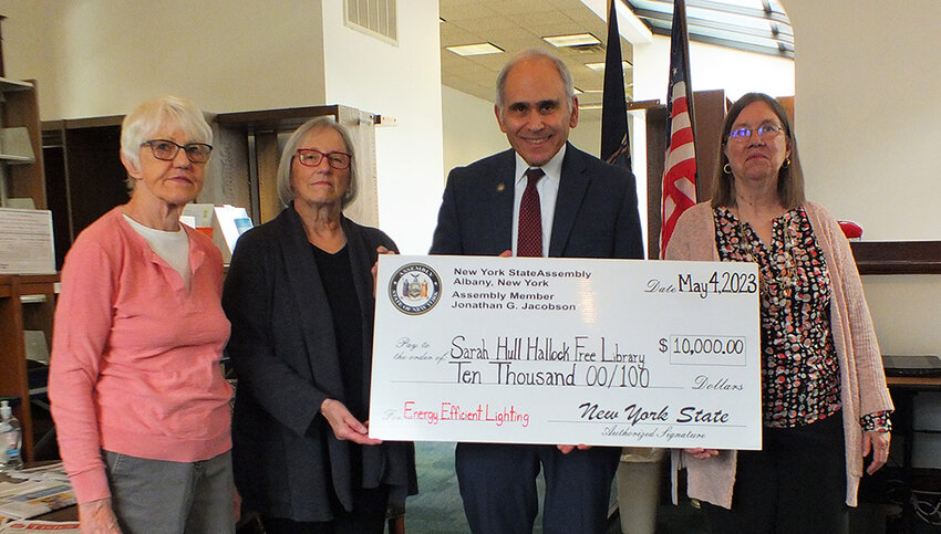 Assemblyman Jonathan Jacobson presented a $10,000 check to the Sarah Hull Hallock Free Library in Milton for new LED lighting. Pictured (l. r.)  Ardis Ketterer, Rosemary Wein, Jacobson, and Lois Skelly.
