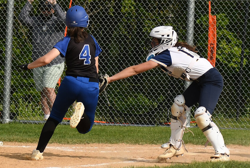 Highland catcher Delaney Reid tags out Wallkill's Mia Ferrante during a non-league softball game on May 9 at Highland High School.