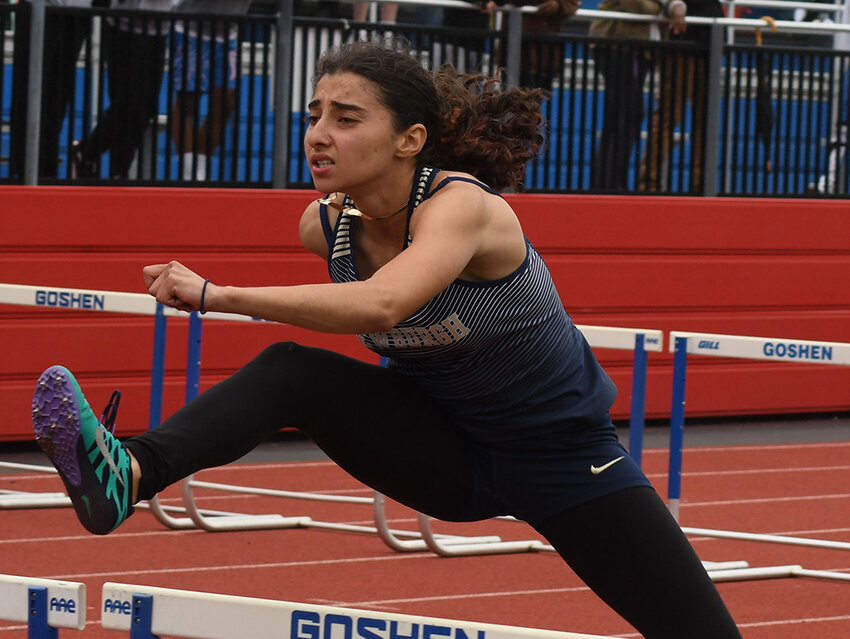 Newburgh's Denisha Cruz runs the 100-meter hurdles during Saturday's OCIAA track and field championships at Goshen High School.