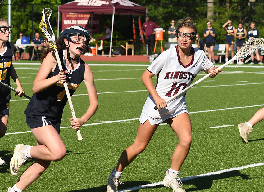 Pine Bush's Lillian Atria brings the ball forward as Kingston's Alanna Stewart defends during Thursday's Section 9 Class A championship girls' lacrosse game at James I. O'Neill High School in Highland Falls.