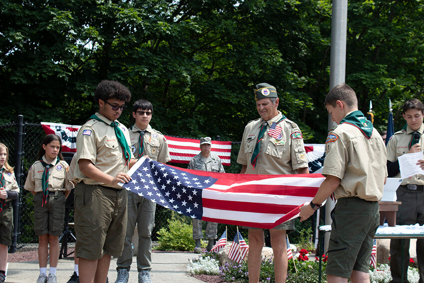 Scouts demonstrate the proper way to fold a flag.