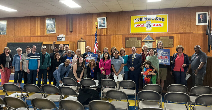 Government officials, postal workers and more gathered for a group photo after the town hall meeting at Teamster&rsquo;s Hall last week.