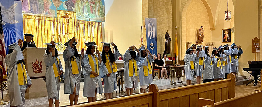 Nora Cronin graduates eagerly move their tassels to the other side of their caps to mark their official graduation status.