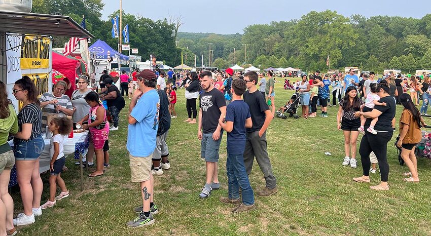 Food trucks and booths serve lines of hungry customers.