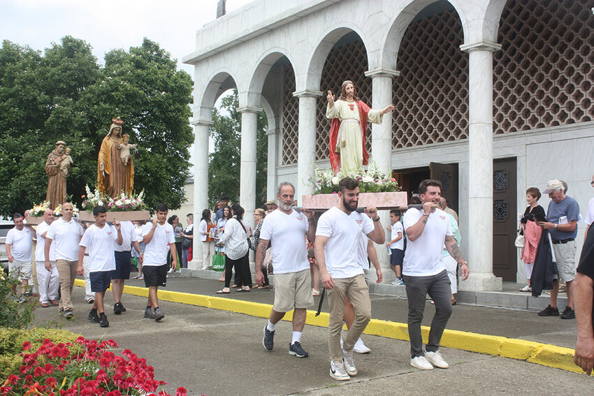 The annual Sacred Heart - Saint Francis Italian Feast culminated with the traditional procession through the streets of Newburgh on Sunday. The men of the parish carried statues of Jesus, St. Anthony and Our Lady of Mount Carmel, celebrating the feast days of the latter two. The procession ended at the Ann Street parking lot, where assorted sausage &amp; peppers, meatballs, eggplant rollatini, prosciutto, pastries and the famous Zeppole awaited.