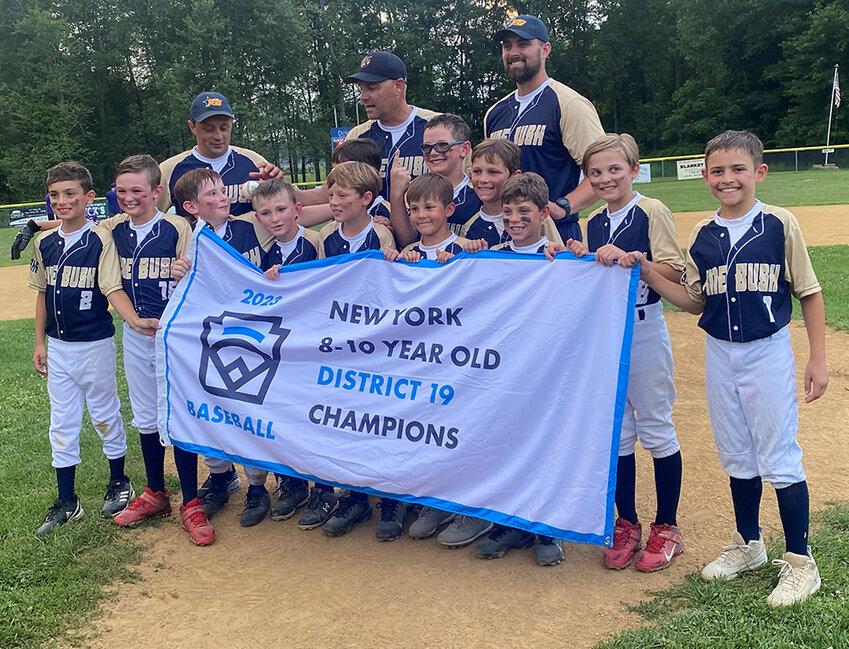 Pine Bush Minors baseball team poses with the District 19 championship banner after Thursday&rsquo;s 7-6 win over Warwick at Crawford Town Park in Pine Bush.