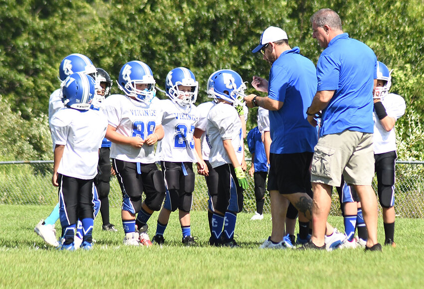 Valley Central players receive the play from their coaches during Saturday&rsquo;s Orange County Youth Football League Division 1 scrimmage at Lasser Park in Salisbury Mills.