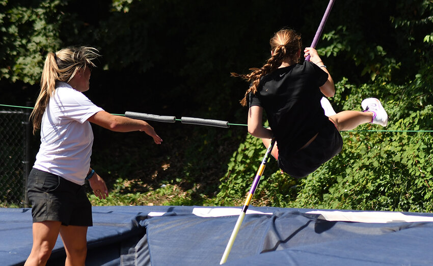 Alexandra Swink does a pole vault drill with assistance from Hudson Valley Flying Circus coach Stephanie Duffy during Friday&rsquo;s Newburgh Pole Vault Clinic at Academy Field in Newburgh.