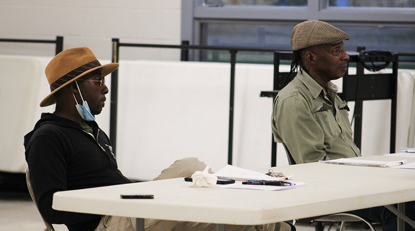 Zoning Board members Corey Allen and Melvin Hales listen to comments and await their turn to speak on the project.