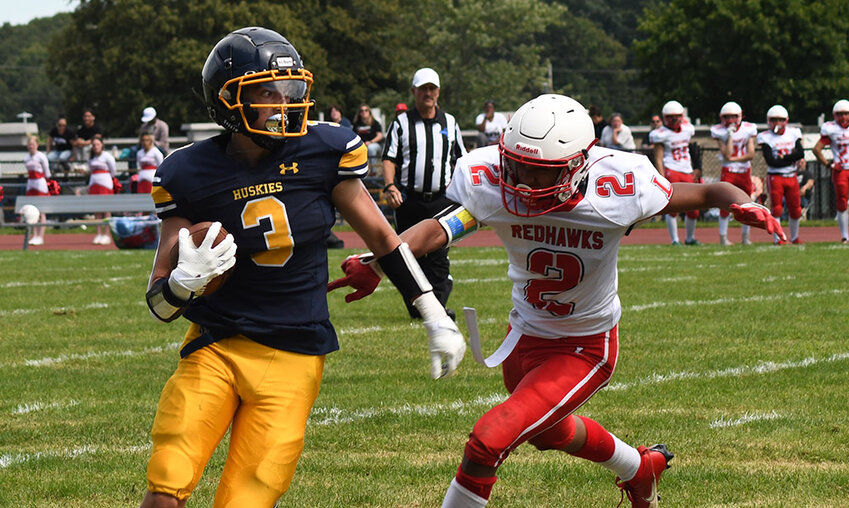 Highland&rsquo;s Joshua Bishop turns the corner as Liberty&rsquo;s Christopher Rodgers pursues during Saturday&rsquo;s non-league football game at Highland High School.