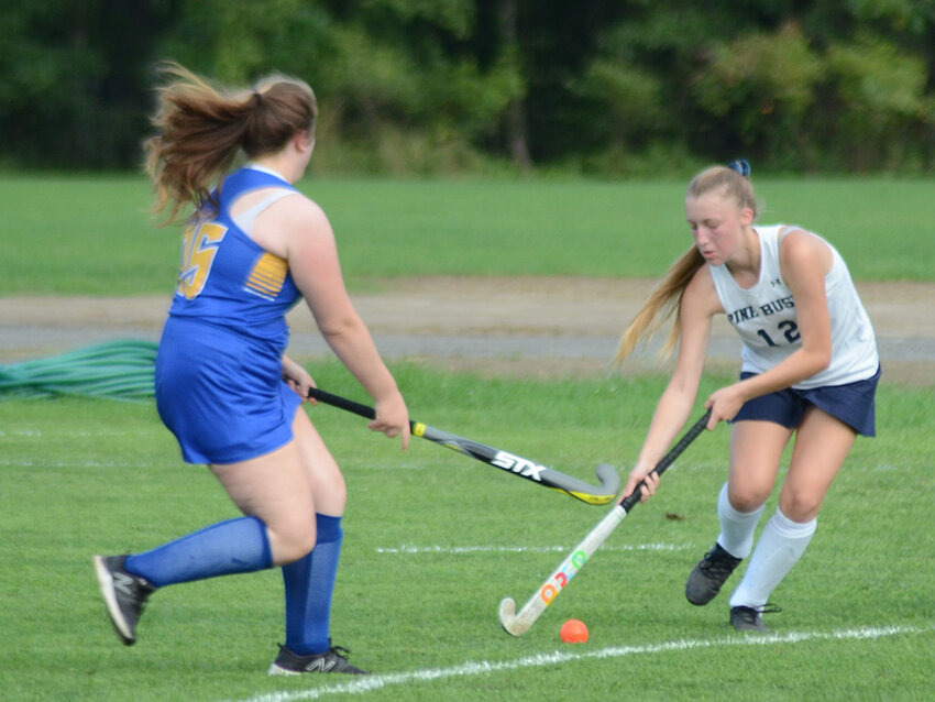Pine Bush&rsquo;s Tristan Myers plays the ball away from Ellenville&rsquo;s Madison Pauley during a field hockey game on Sept. 12, 2022.