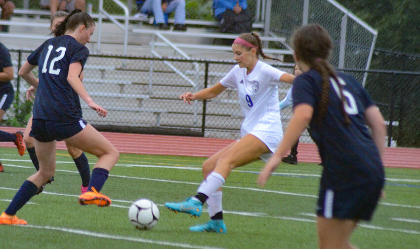 Valley Central's Hannah Stahl plays the ball forward as Wallkill's Tristan Loupe defends and Paige Badner looks on during a non-league girls' soccer game on Sept. 6, 2022, at Wallkill Senior High School.