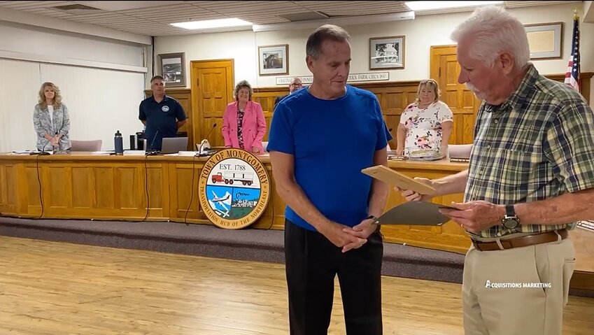 Town Supervisor Ronald Feller hands John Luffman his plaque and certificate.