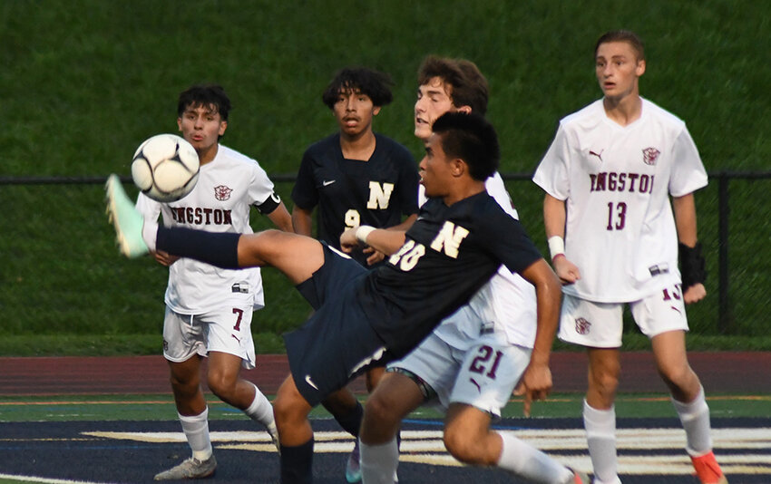 Newburgh's Olvin Flores kicks the ball over his head toward the goal during Wednesday's OCIAA Division I boys' soccer game at Academy Field in Newburgh.