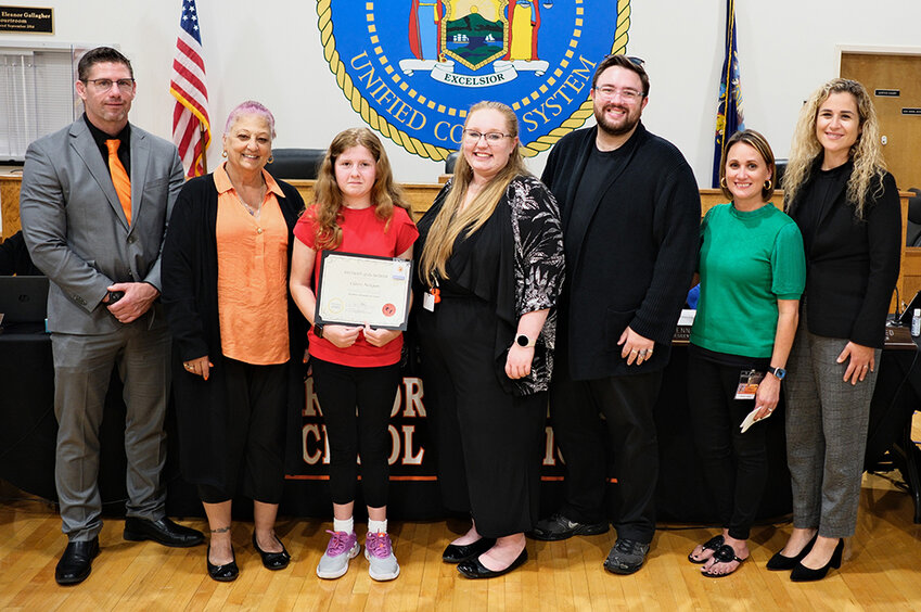 Claire Neligan holds her Marlboro Elementary School Student of the Month certificate. Pictured L-R Superintendent Michael Rydell, board member JoAnn Reed, Neligan, music teacher Susan Johnston, band teacher Zach Povall, Asst. Principal Sarah Amodeo and Principal Jena Thomas
