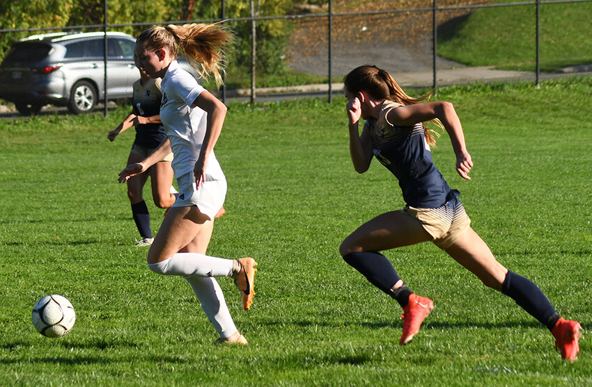 Pine Bush's Kathryn Cragan dribbles the ball toward the goal as Newburgh's Riley Frederick pursues during an OCIAA Division I girls' soccer game on Oct. 3 at Newburgh Free Academy North.