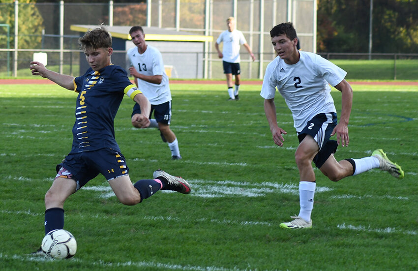 Highland's Zachary Osterhoudt prepares to kick the ball down the field as Mount Academy's Rob O'Connell (2) and Dwayne Anrold (13) pursue during Thursday's MHAL boys' soccer game at Highland High School.