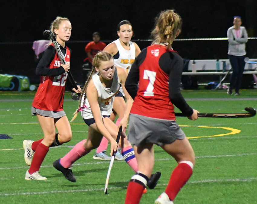 Pine Bush's Tristan Myers brings the ball down the field as Red Hook's Liv Christensen defends and Maddie Boyd (22) and Pine Bush's Kara Wittenberg look on during a MHAL field hockey game on Oct. 10 at Pine Bush High School.