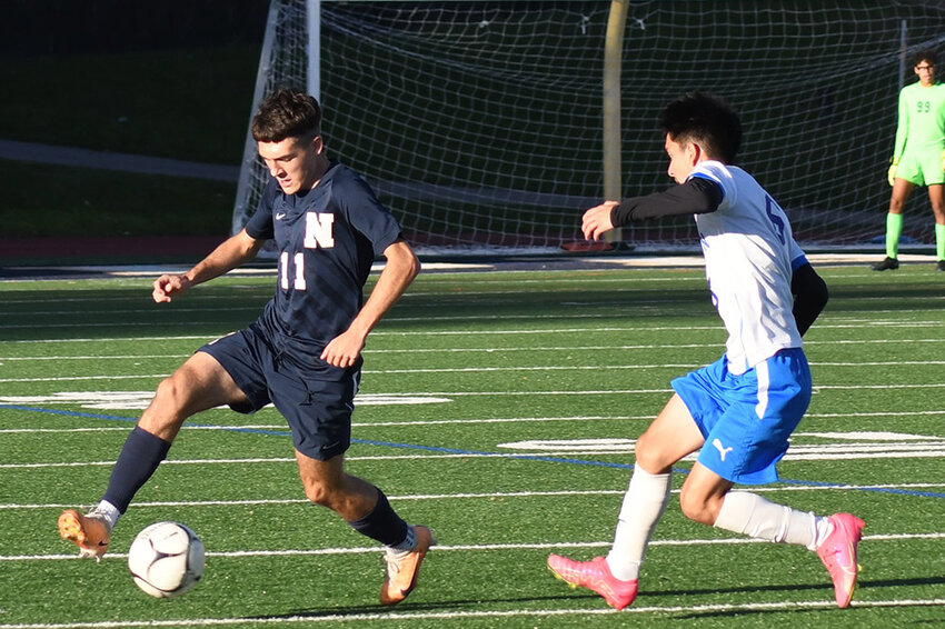 Newburgh's Frank Mandato plays the ball in front of Middletown's Jesus Godinez during Friday's OCIAA Division I boys' soccer game at Academy Field in Newburgh.